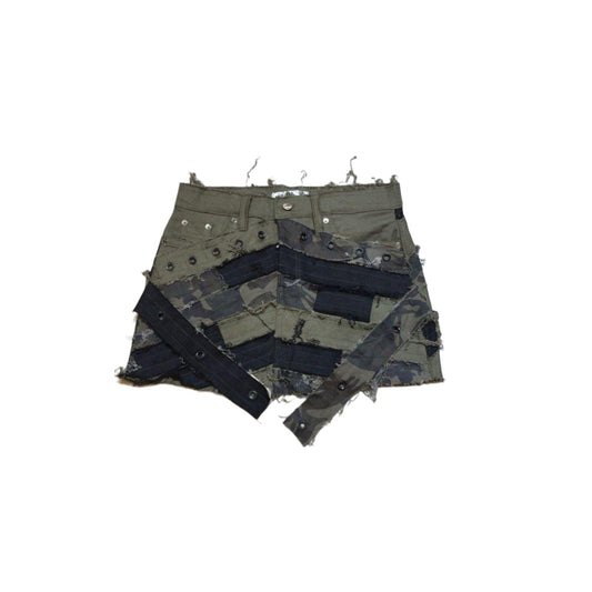 A skirt with a camouflage pattern in shades of black, gray, and green, appears to be made of a denim fabric.